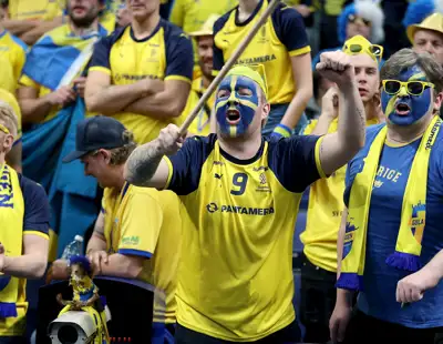 Glad manlig supporter med flagga